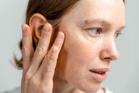 Close up of a woman in her 30s with firm, healthy skin